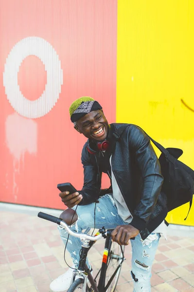 African young man with fixed gear bicycle.