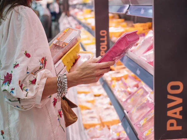 woman who buys meat at the super market