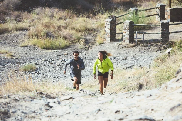 Dos amigos jóvenes corriendo en el bosque — Foto de Stock