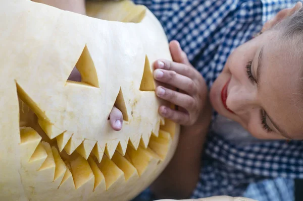 Menina esculpindo abóbora Halloween ao ar livre . — Fotografia de Stock