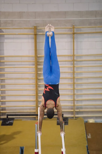 Чоловіча гімнастка виступає на гімнастичних кільцях — стокове фото