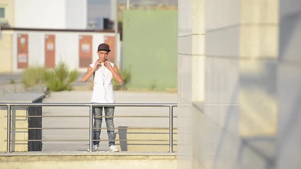 Teenager mit Smartphone und Kopfhörer auf der Straße — Stockvideo