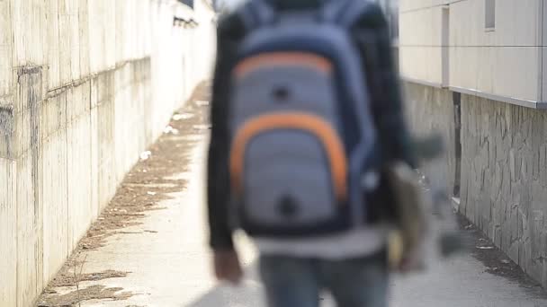 Young man with backpack and skateboard — Stock Video