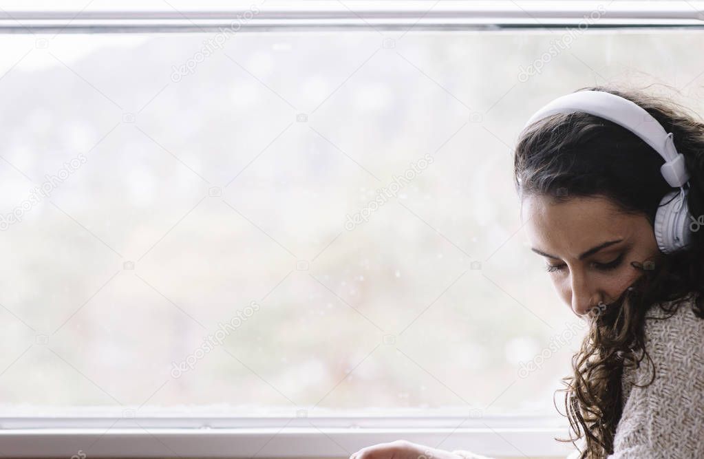 Teen passenger listening to the music traveling in a train