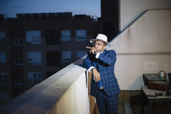 man smoking with hat