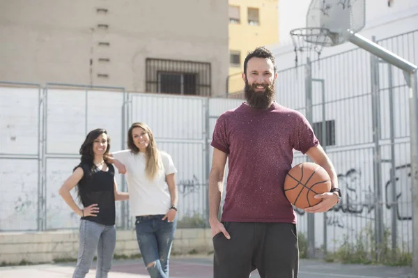 Three friends playing basketball together