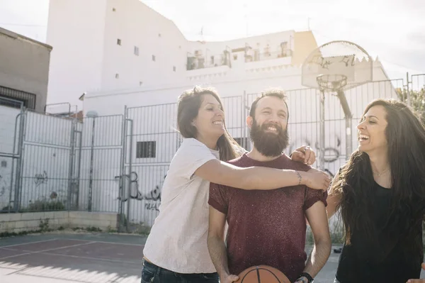 Three friends playing basketball together