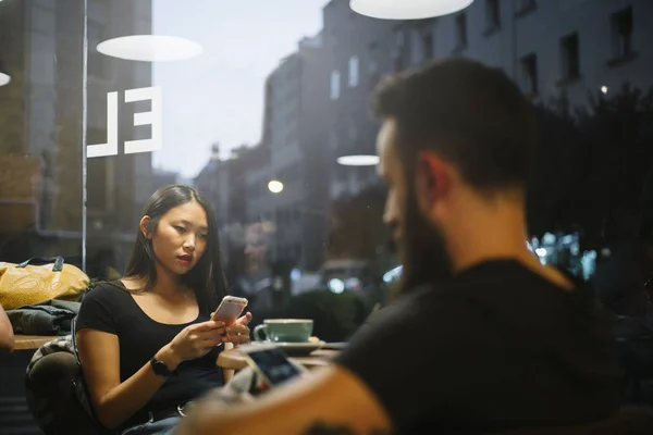 Csípő ember és egy ázsiai nő kávézó. — Stock Fotó