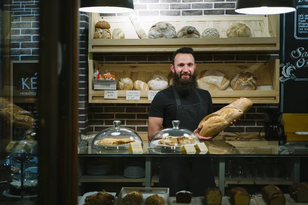 Hombre hipster trabaja en la panadería — Foto de Stock