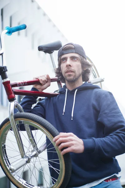 Male BMX rider on street with phone