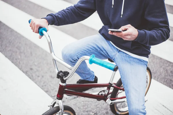 Masculino BMX cavaleiro na rua com telefone — Fotografia de Stock