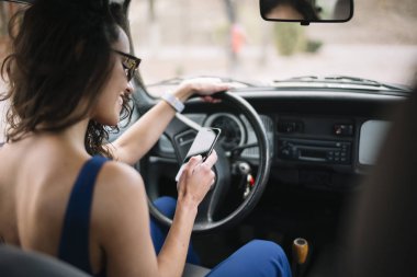 Cep telefonu arabada kullanan güzel genç kadın.