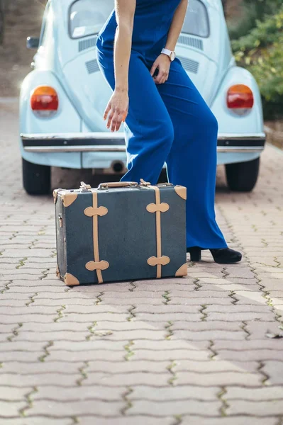 beautiful woman with suitcase and car