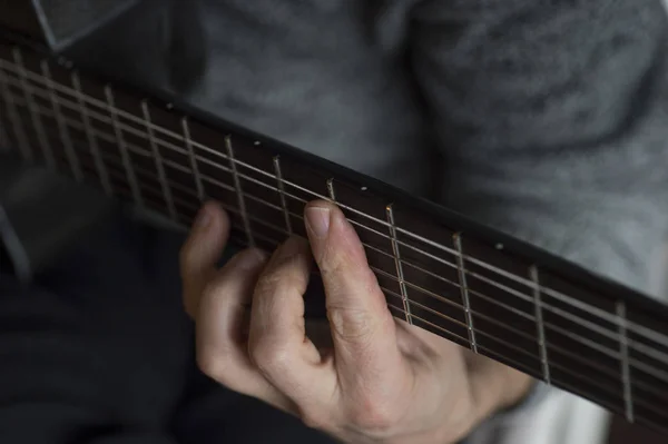 Homem idoso tocando guitarra de fibra de carbono — Fotografia de Stock