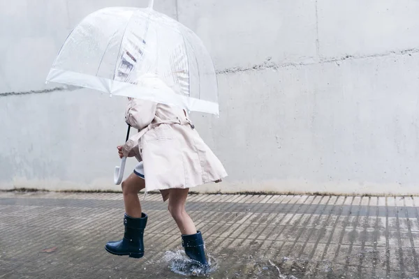 Little girl with blue eyes  and big clear umbrella. — Stock Photo, Image