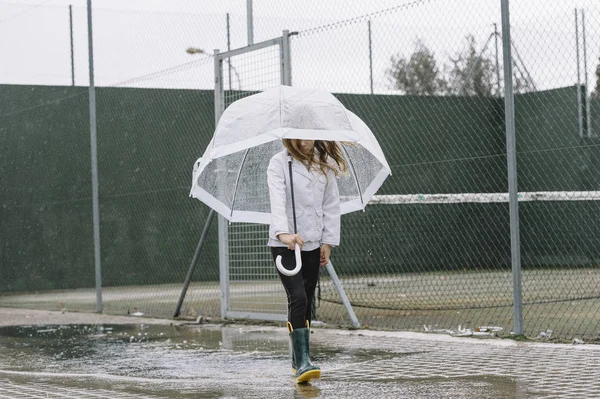 Little girl with blue eyes  and big clear umbrella. — Stock Photo, Image