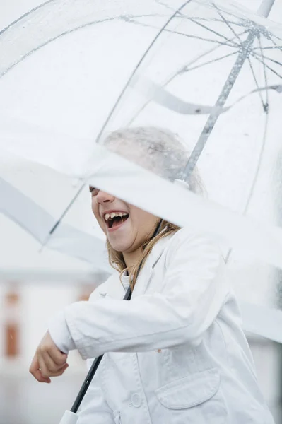 Little girl with blue eyes  and big clear umbrella. — Stock Photo, Image