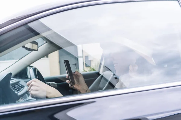 Mulher bonita usando seu telefone celular no carro — Fotografia de Stock