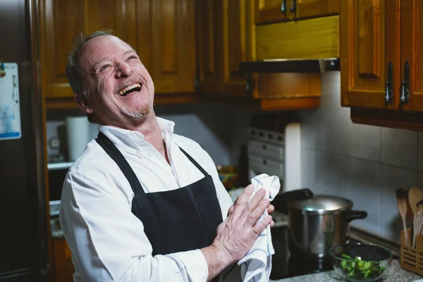 Hombre de 59 años trabajando en la cocina de su casa . — Foto de Stock