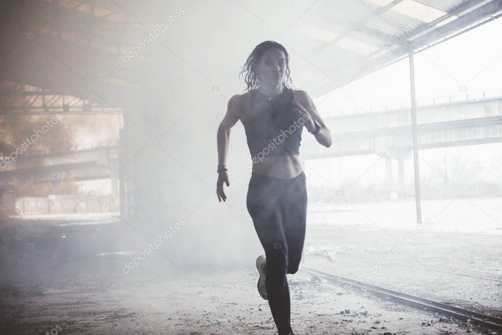 Woman doing sport in the open air, on rainy day