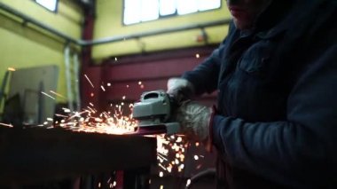 Adam öğütücüyle çalışıp metal kesiyor..