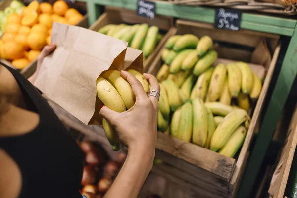 women buying bananas in super market
