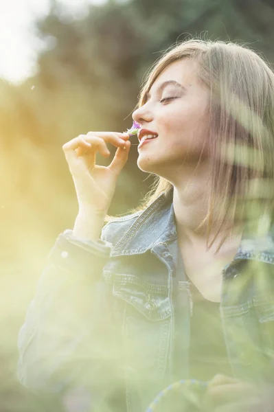 Happy teen girl in the forest with flowers — Stok Foto