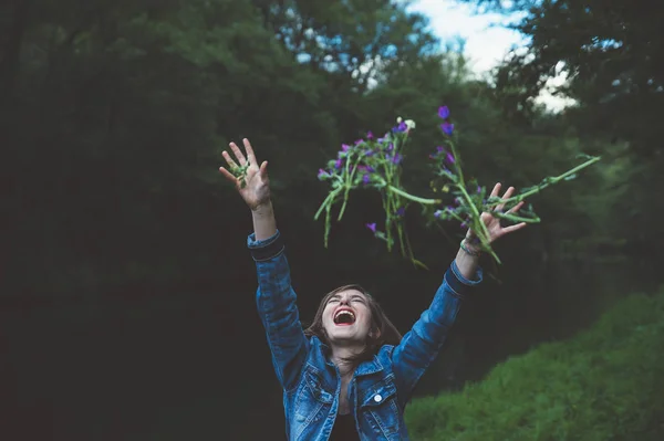 Happy teen girl in the forest with flowers — Stok Foto