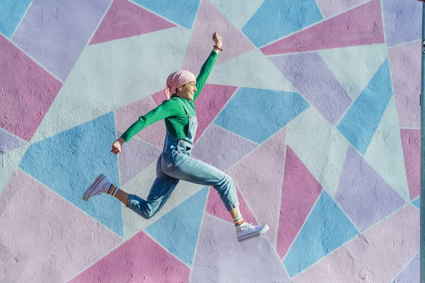 Mujer saltando con bufanda rosa, tiene cáncer — Foto de Stock