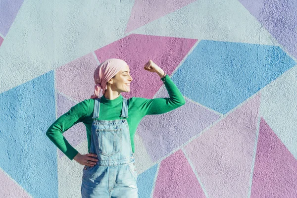 Retrato de mujer con pañuelo rosa, tiene cáncer. Mostrar el brazo como una señal de fuerza — Foto de Stock