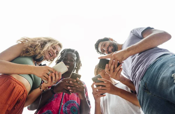 Group of friends in the street with smartphone