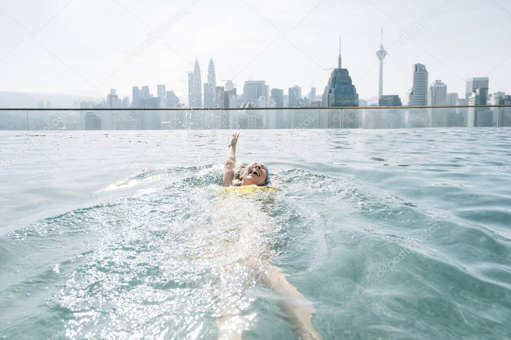 Woman swimming in the infinity pool