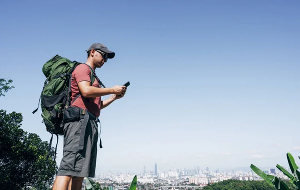 Digital nomad man traveling the world with smartphone