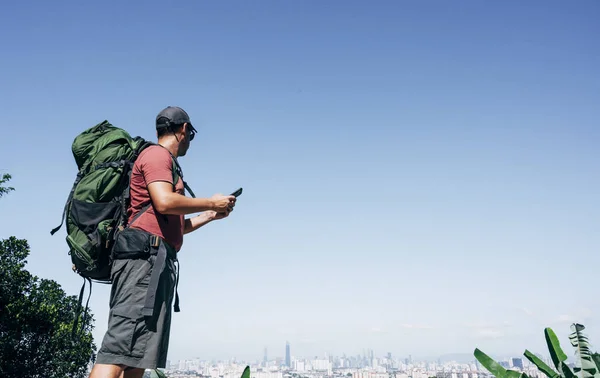 Digital nomad man traveling the world with smartphone