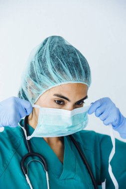 Hemşire koruyucu maske takıyor.