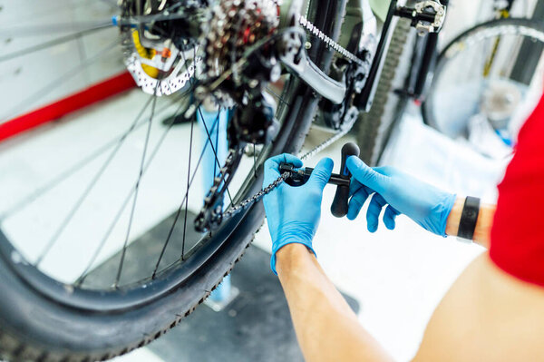 Mechanic fixing the electric bicycle