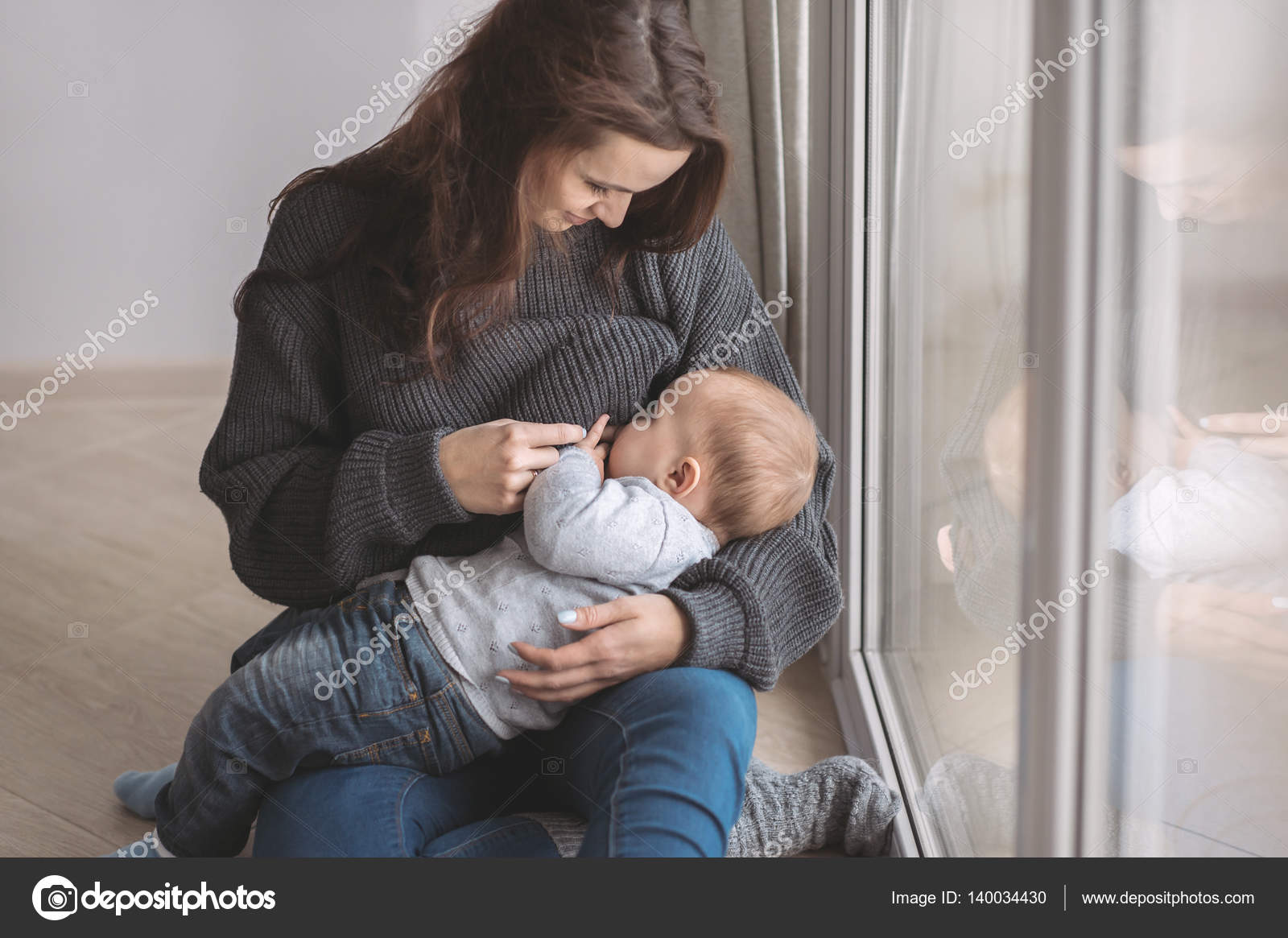 Young mother breastfeeding her baby — Stock Photo © RomanovaAnna 140034430