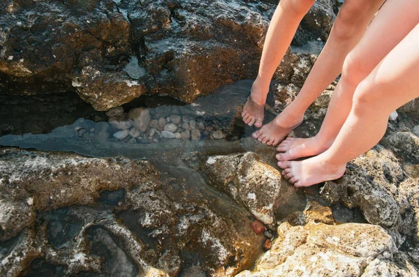 Kids feet wading in sea