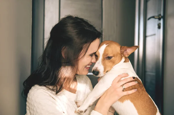 Smiling woman hugging her pet — Stock Photo, Image