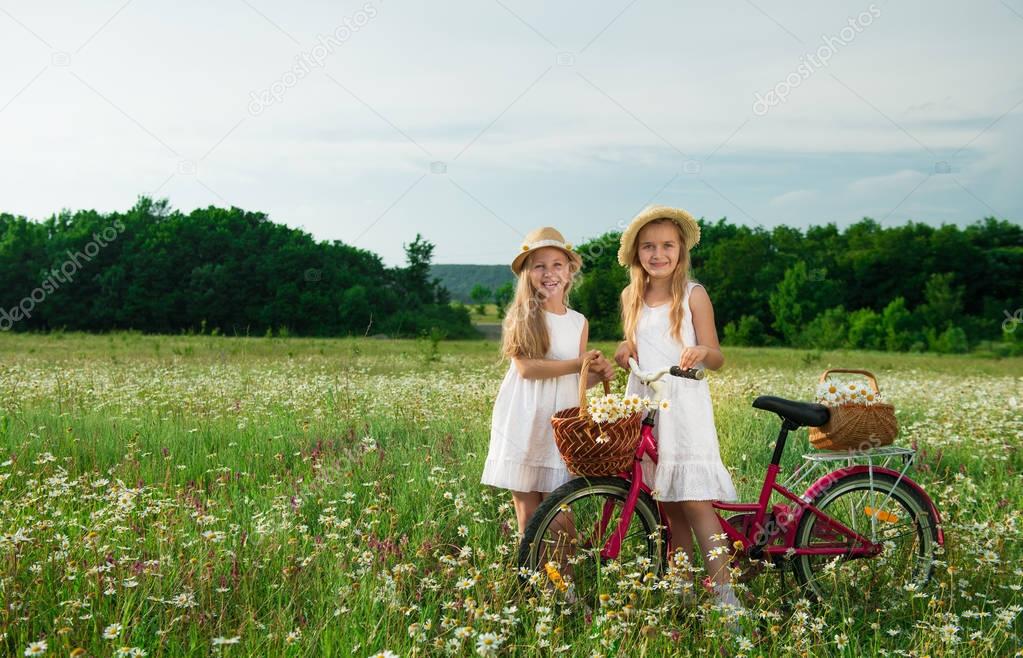  Girls staying near bicycle