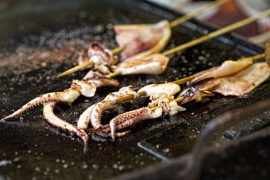 Fried calamars on asian street food market  clipart