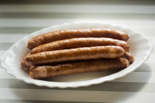 Frankfurter sausages on white plate — Stock Photo, Image