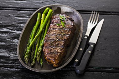 Grilled steak with green vegetables clipart