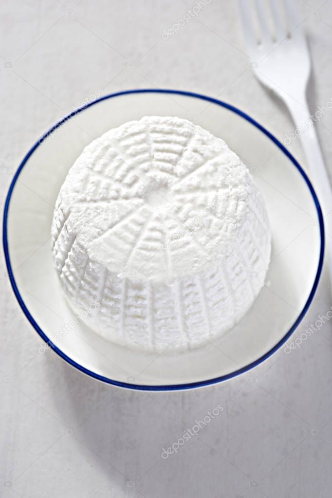 Ricotta cheese on white plate 