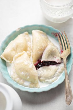 Yaban mersini ve krema ile mantı. Berry meyve tatlı pierogi.