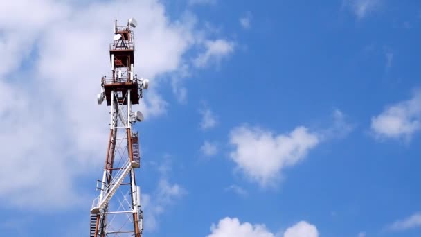Telecommunication Tower With Antennas And Repeaters Against Blue Sky And Clouds