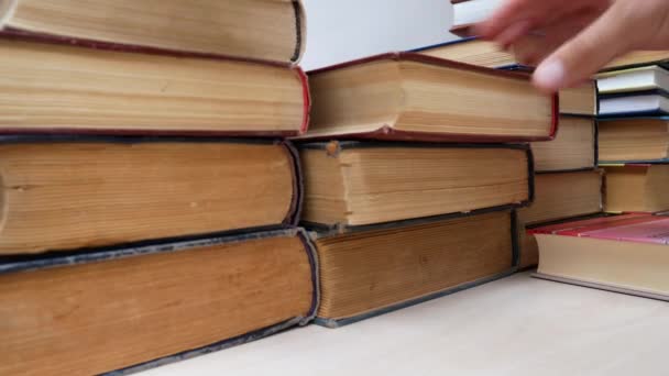 Student Folding Old Books On Stack On Bookshelf — Stock Video