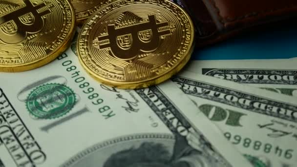 Monete d'oro Bitcoin BTC rotanti con portafoglio marrone e banconote da 100 dollari — Video Stock