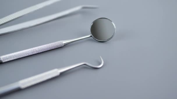 Set of dentist tools on gray background — Stock Video