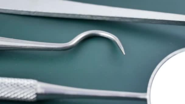 Medical dental instruments on green surface — Stock Video
